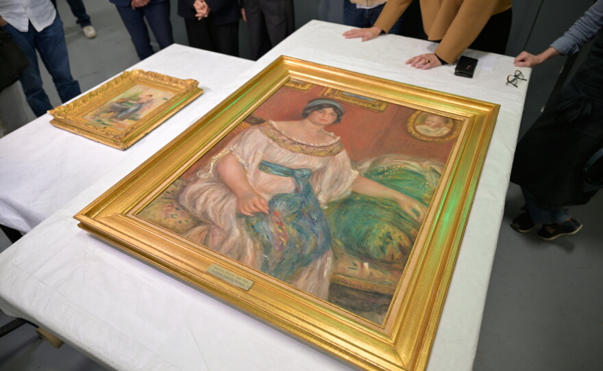 Recovered paintings "Portrait of Madame Colonna Romano", right, and "Young Woman at the Well," stolen from the Renoir Museum in Cagnes-sur-Mer are on display at the Interdisciplinary Centre for the Conservation and Restoration of Heritage in Marseille, France, Monday Oct. 12, 2026.