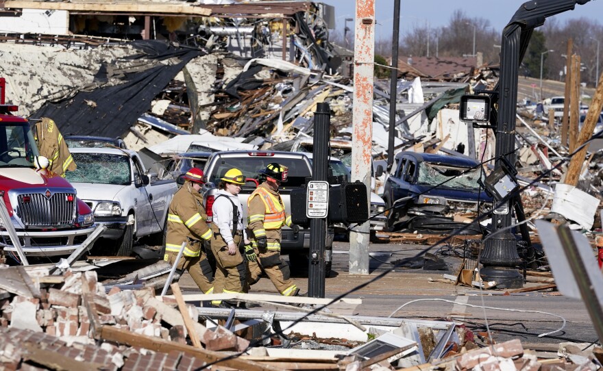 Authorities on Saturday survey damage from a tornado in Mayfield, Ky.