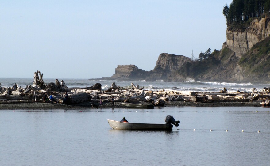 A tribal fisherman brings up his nets near the mouth of the Quinault River on the coast of Washington state. Climate change is threatening tribal families, who have worked the same fishing grounds along this river for generations.