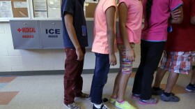 Detained immigrant children line up in the cafeteria at the Karnes County Residential Center, a temporary home for immigrant women and children detained at the border, in Karnes City, Texas, Sept. 10, 2014.