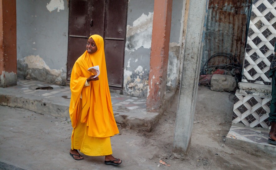 A schoolgirl walks along a street in Mogadishu.
