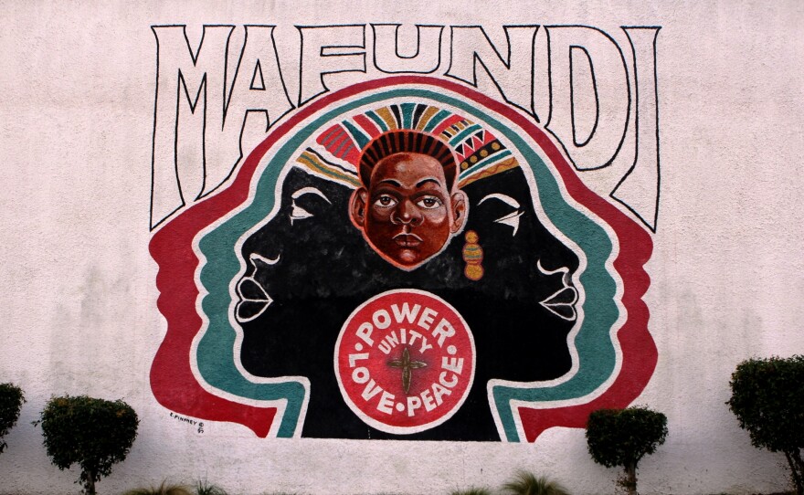 The Mafundi Institute mural is shown on a historic building in Watts. It's long been a hub of local arts and activism, and is now home to the Mafundi auditorium and the Watts Coffee House and restaurant.
