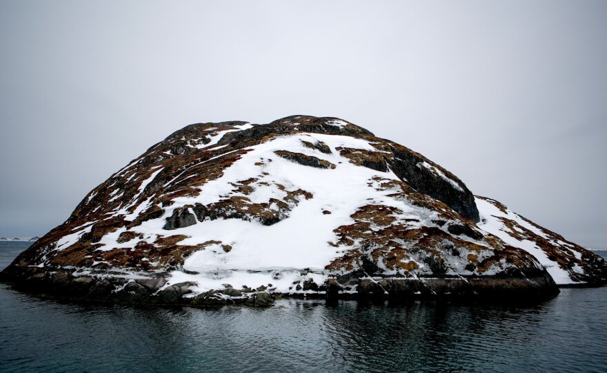 A small island sits in the middle of Kangeq's old harbor.