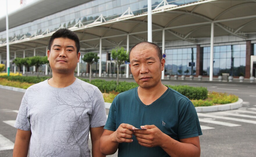 Wu Youfu (at left) and his uncle, Wu Dexi, a farmer, took Youfu's grandmother to visit Luliang's airport, a popular attraction for curious local farmers. It was conceived when this coal city was booming. Now the economy is in recession.