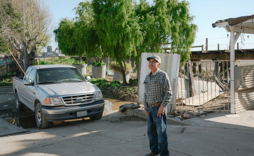 Antonio Hueso, 72, stands in the driveway of his home in Pajaro, California after floodwaters in mid March flooded the first floor of his home and submerged his truck. He's considering repairing his home of 48 years and selling.
