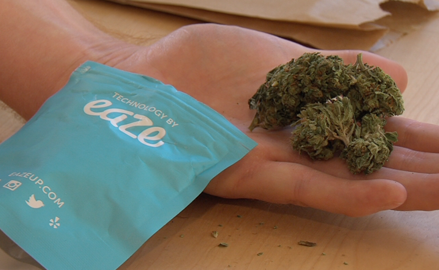An eighth of an ounce of marijuana is seen next to the packaging of the pot delivery app Eaze, Nov. 6, 2015.