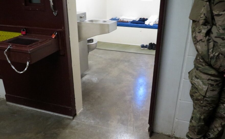 A U.S. military service member stands outside a prison cell at Camp 5. (Photo reviewed and cleared by U.S. military.)