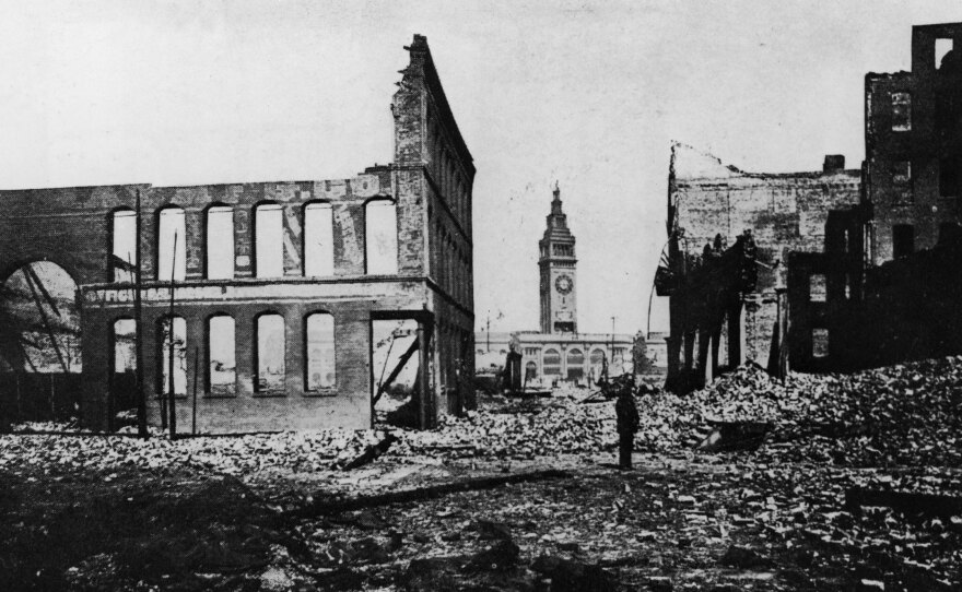 The Ferry Building and clocktower seen through rubble after the 1906 San Francisco earthquake and subsequent fires.
