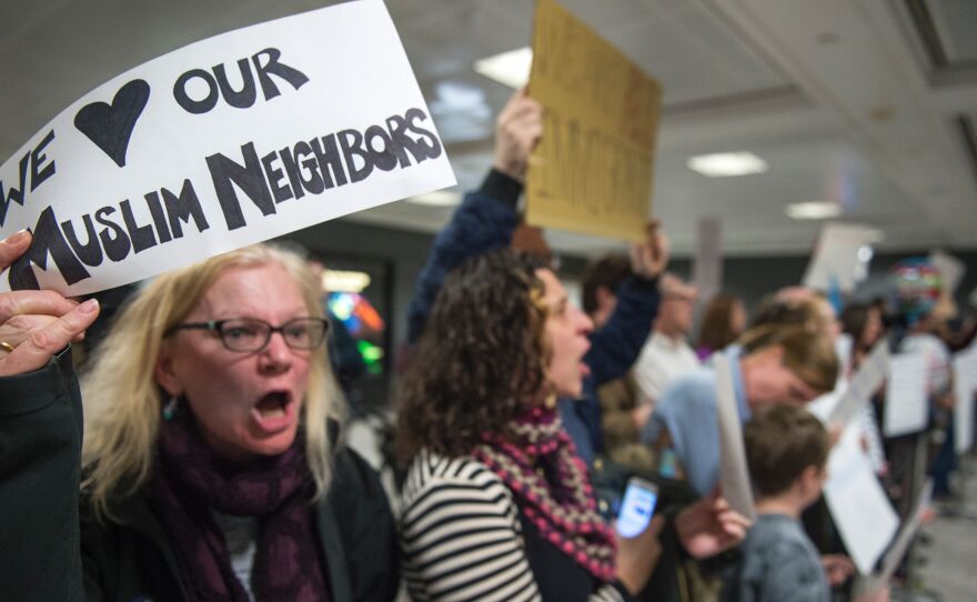 Protesters came to the international arrivals area of the Washington Dulles International Airport on Saturday.