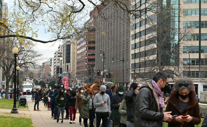 People line up to get tested for COVID-19 at a testing site in Washington, D.C., on Wednesday. More than 1 million Americans tested positive for COVID-19 on Monday, according to data from Johns Hopkins University.