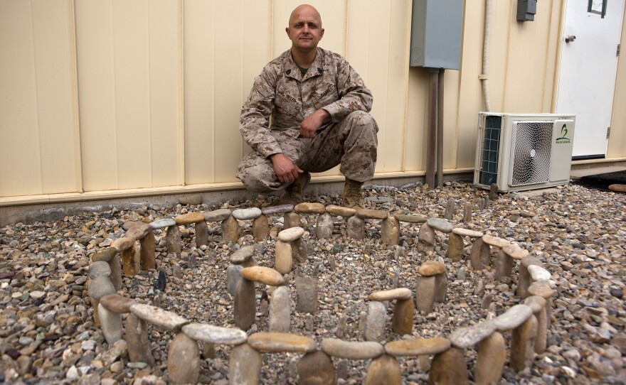 Gunnery Sgt. Gregory Miller with his model of Stonehenge at Camp Bastion, Nov. 24, 2013.