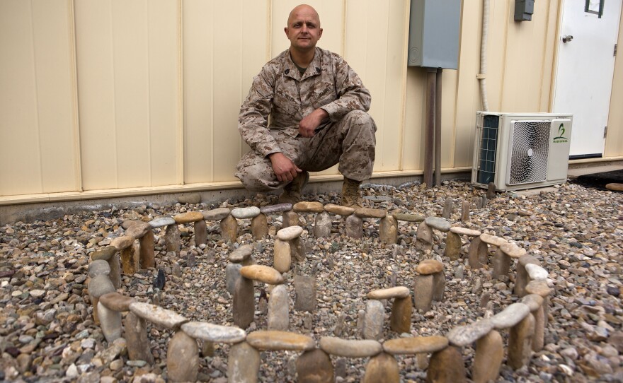 Gunnery Sgt. Gregory Miller with his model of Stonehenge at Camp Bastion, Nov. 24, 2013. 