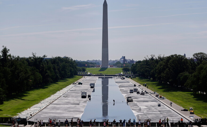 Workers refill the Lincoln Memorial Reflecting Pool on Friday, after a weeks-long project to resurface and repaint the basin.
