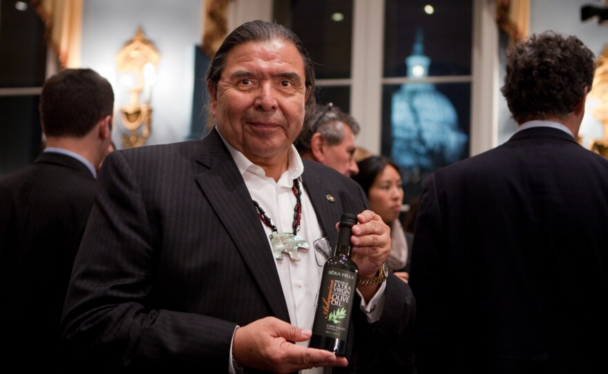 Marshall McKay, Tribal Chairman of Yocha Dehe Winton Nation, displays a bottle of his premium SÉKA HILLS Extra Virgin Olive Oil from Capay Valley, Calif. Capay Valley is an agricultural region with a climate similar to the Mediterranean providing an ideal environment for cultivating olive groves.