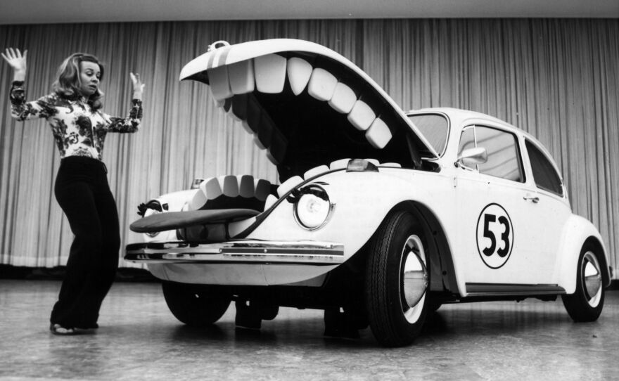 Herbie, the anthropomorphic Volkswagen Beetle featured in the 1969 Disney film The Love Bug, terrorizes a young woman at a car show in Berlin in June 1972.