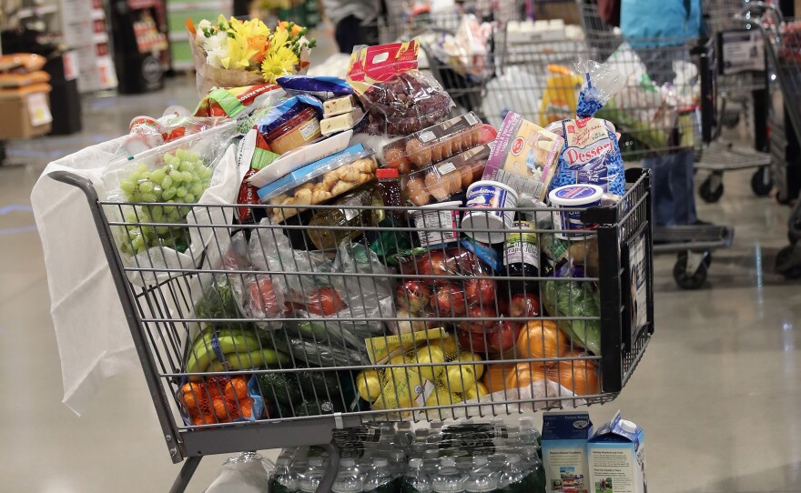 A shopper's full cart is placed on the checkout line at the ShopRite supermarket on April 3, 2020 in Plainview, N.Y. A year later, prices for most goods have jumped, according to government data on Wednesday, as conpanies struggle to secure critical raw materials amid supply constraints.