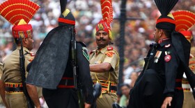 Pakistani Rangers (in black) goosestep at the Wagah border; India's border guards are in tan. The 30-minute ritual show of force and bluster happens every evening of the year. Hundreds of spectators come to watch the show -- from both sides of the border.