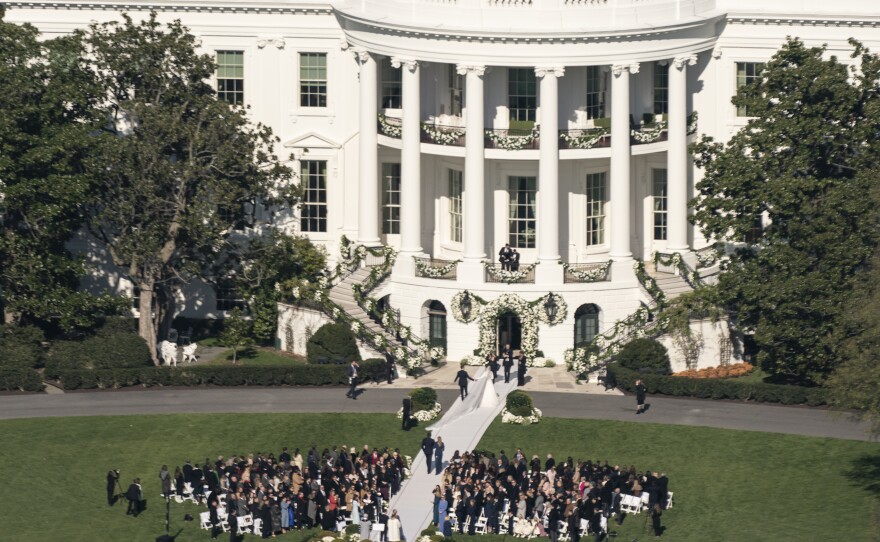 President Biden's granddaughter Naomi Biden and Peter Neal walk down the aisle on the South Lawn of the White House.