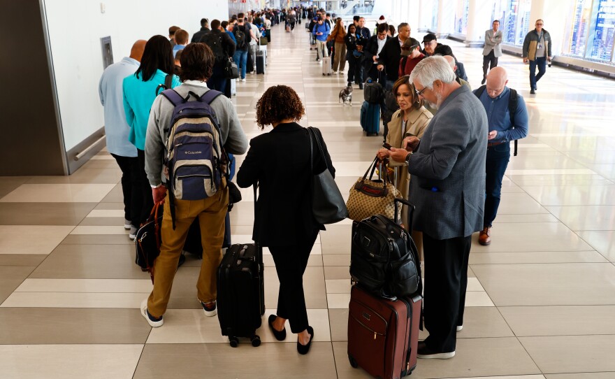 Passengers stand in the TSA pre-check line at LaGuardia Airport on Thursday in New York.