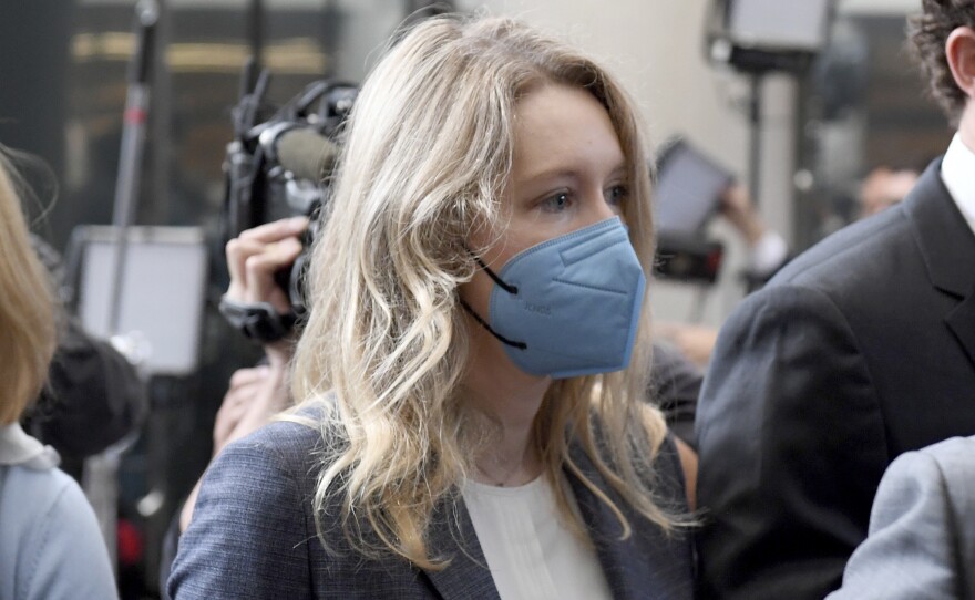 Elizabeth Holmes, center, walks into the federal courthouse for her trial in San Jose, Calif., Wednesday.