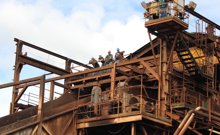 Workers at the mill look on as the last piece of the final harvest drives up to the factory to be processed.