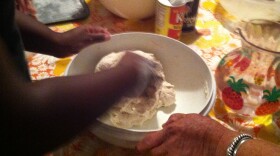 The dough is kneaded before being fried in a large pan of grease.