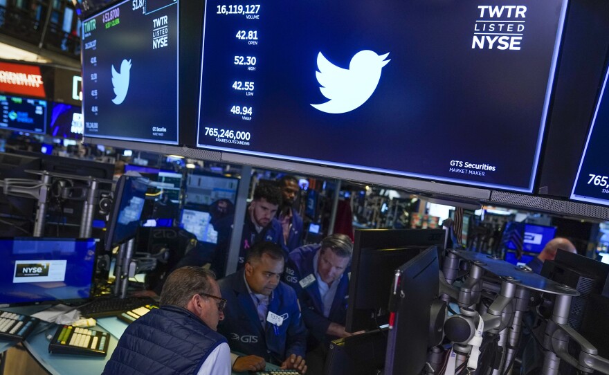 Traders gather around a post as Twitter shares resume trading on the floor at the New York Stock Exchange in New York, on Oct. 4, 2022.