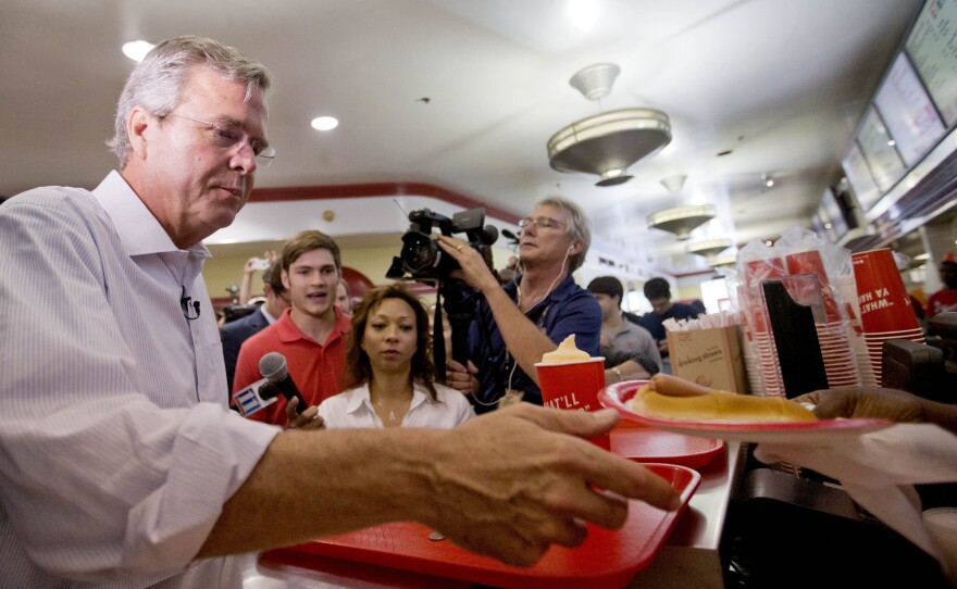 Jeb Bush is handed a "yellow dog" at Varsity Drive-In in last month in Atlanta. That's a hot dog with mustard.