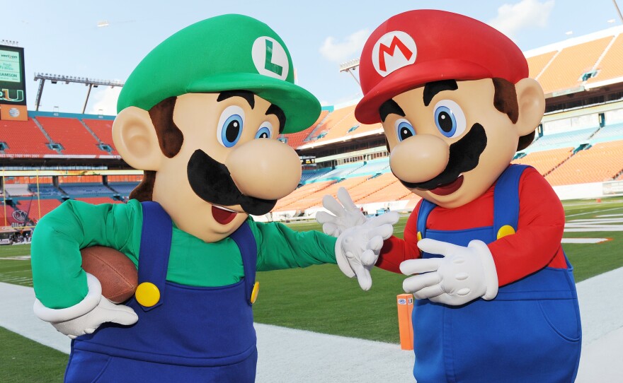 Mario (right) and his brother Luigi, pictured before a college football game in 2014 in Florida, are the iconic characters from Super Mario Bros. video game franchise.