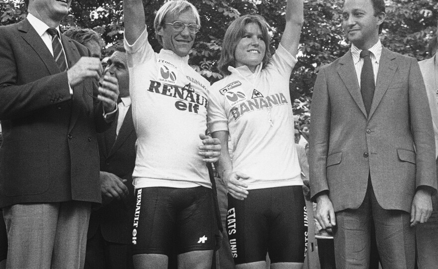 Laurent Fignon, left, of France, and Marianne Martin of Boulder, Colo., hold up their trophies in Paris after winning the men's and women's Tour de France cycling races on July 23, 1984.
