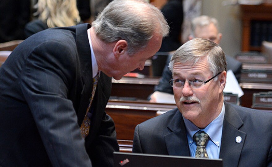 Sens. Warren Limmer, left, and Bill Ingebrigtsen, talk in the Senate chamber. Limmer said he has been scolded for looking at his colleagues during debate before, and had "to beg forgiveness to the Senate president."