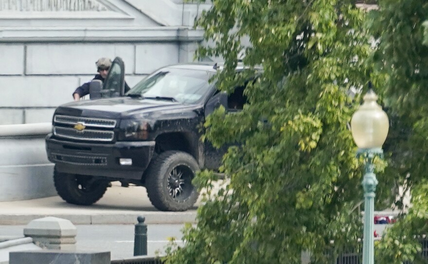 A man who claimed to have a bomb in a pickup truck near the Capitol surrendered to law enforcement after an hours-long standoff Thursday. The incident prompted a massive police response and the evacuations of government buildings and businesses in the area.