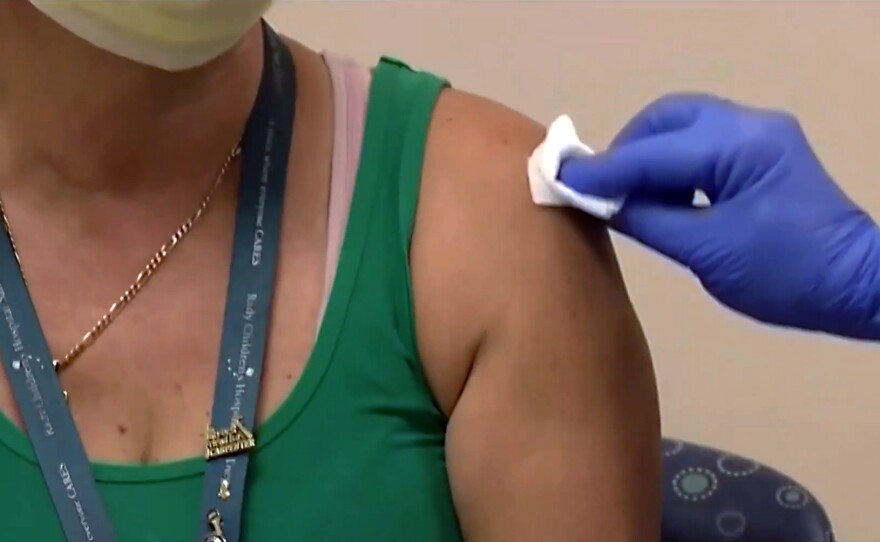 Sonia Garcia, a technician at Rady Children's Hospital, getting the COVID-19 vaccine on Dec. 15, 2020.