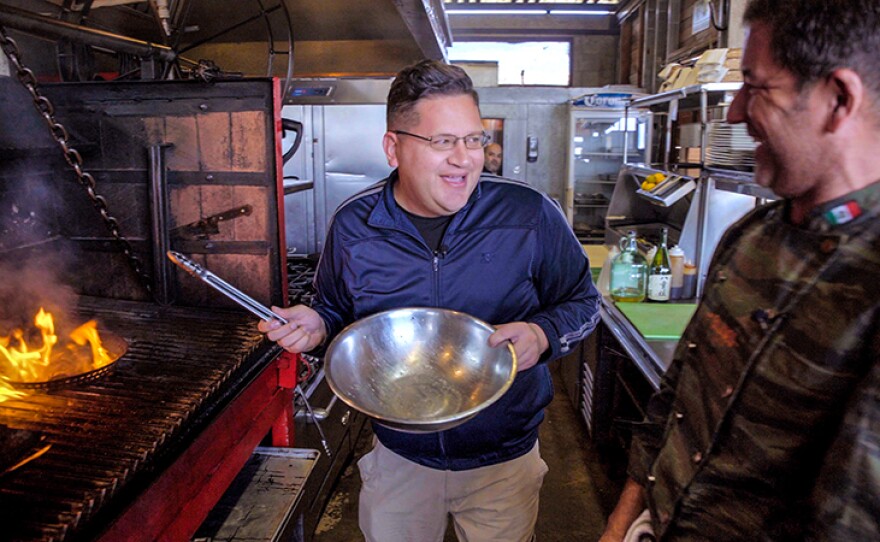 Host Jorge Meraz makes fire in the kitchen at El Esperanza restaurant, while cooking together with chef Miguel Angel who founded Baja Med Cuisine. Valle de Guadalupe, Baja Calif.