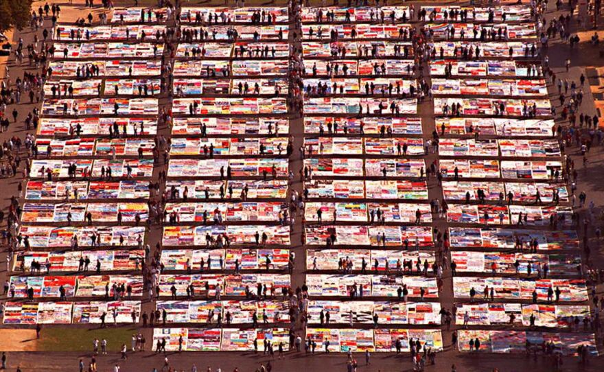 Friends and family of AIDS victims visit the AIDS Memorial Quilt, displayed on the National Mall in October 1996.