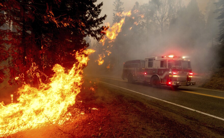 A firetruck drives along state Highway 168 while battling the Creek Fire in the Shaver Lake community of Fresno County, Calif., last month.