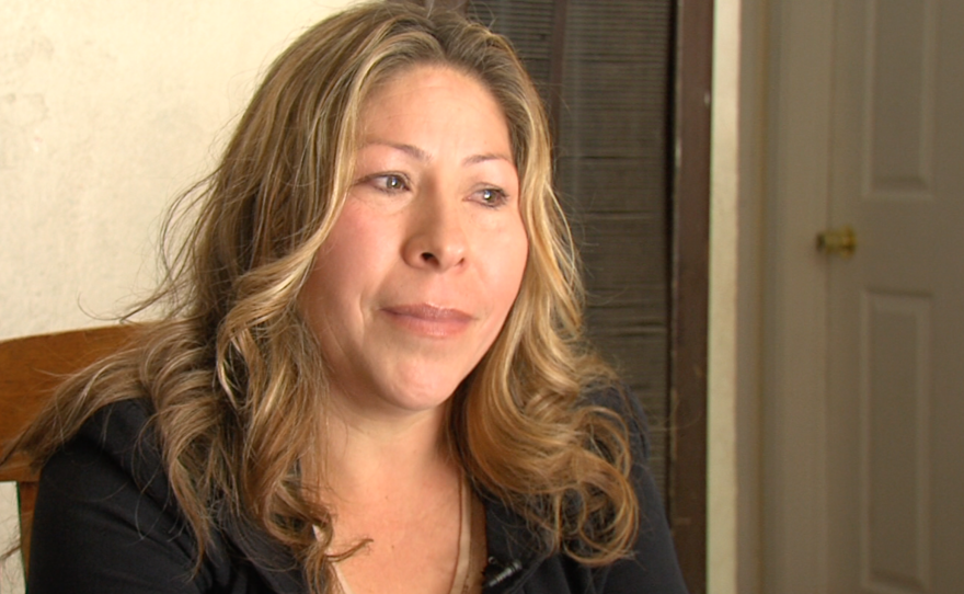 Maria Puga sits in her house five years after her husband's death, May 15, 2015.