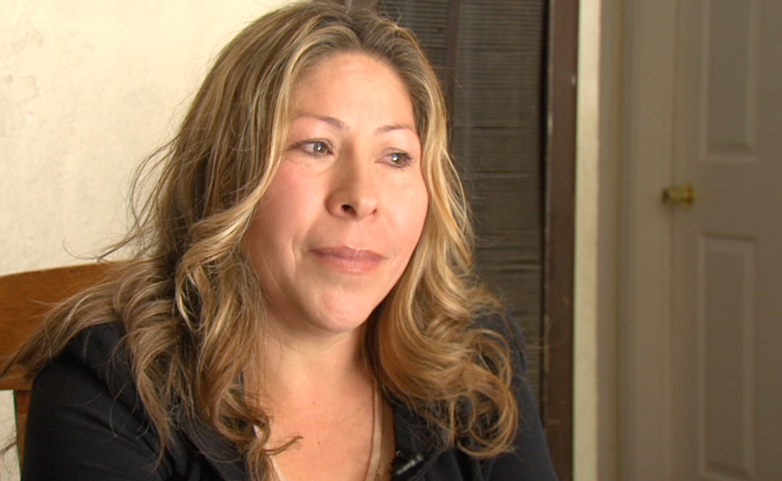 Maria Puga sits in her house five years after her husband's death, May 15, 2015. 