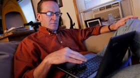 Kevin Evans relaxes in his small apartment after arriving home from work. Evans, who lost income and his home in the recession, is now having his wages garnished after falling behind on his credit card payments.