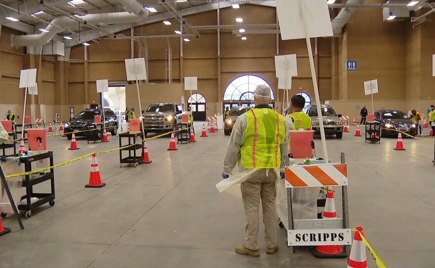 Cars line up at the vaccination super station at the Del Mar Fairgrounds. Feb. 12, 2021.