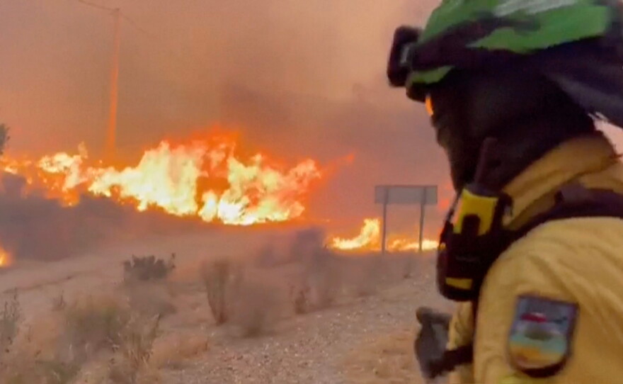 This image made from video provided by INFOCA shows firefighters battling a wildfire near Los Gallardos, Almeria, Spain, on Thursday, July 9, 2026.
