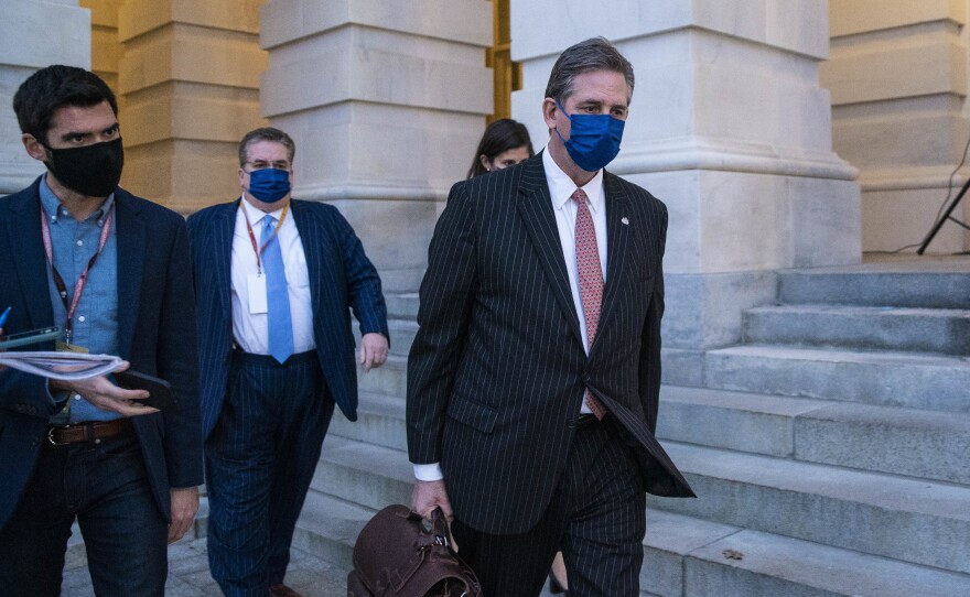 Bruce Castor, defense attorney for former President Donald Trump (center), departs the U.S. Capitol following the first day of the impeachment trial on Monday.