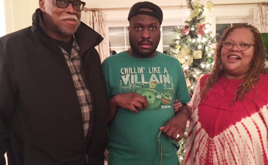 Ronald Hampton, his son Quintin and wife Quintina Hampton pose for a family picture.