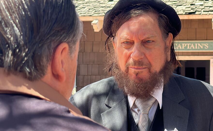 Conference speaker J.J. Hurtak, Ph.D. is shown being interviewed by KPBS reporter John Carroll at Marina Village in San Diego on April 21, 2023.