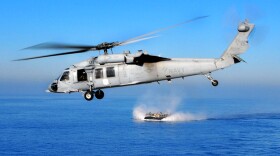 An MH-60S Knighthawk helicopter flies over the Pacific Ocean, Dec. 6, 2008