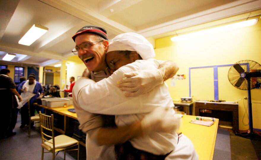 Yvonne Shields (right) hugs one of her volunteers at the Manhattan community kitchen where she works as a sous chef. A resident of Highbridge Gardens in Manhattan, Shields is also a member of the local organization Community Voices Heard.