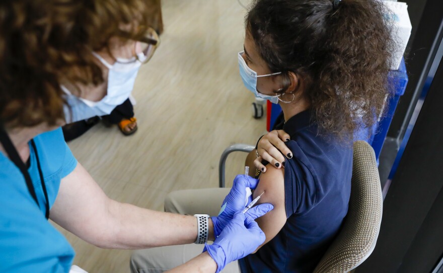 A teen gets a dose of Pfizer's COVID-19 vaccine at Holtz Children's Hospital in Miami on May 18. Nearly 7 million U.S. teens and pre-teens (ages 12 through 17) have received at least one dose of a COVID-19 vaccine, so far, the CDC says.