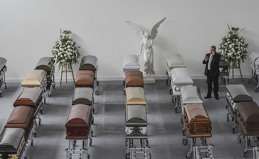 Some coffins for players of the Brazilian football team Chapecoense Real sit at a mortuary in Medellín, Colombia, on Wednesday. Investigators worked Thursday to finish identifying 71 victims of the plane crash as members of the public were left reeling by a harrowing recording of the pilot in the flight's final minutes.