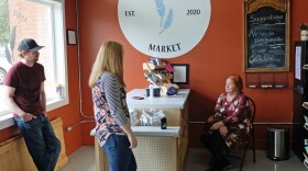 Alex and Caileen Ostenson visit with customer Karen Howell at Main Street Market in Evansville, Minn.
