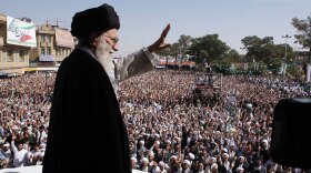 Iran's supreme leader, Ayatollah Ali Khamenei, waves to the crowd in a public gathering Tuesday during his visit to the city of Qom, 78 miles south of the capital Tehran. His trip is widely seen as an attempt to shore up his own status and legitimacy after last year's contentious presidential elections, in which he supported President Mahmoud Ahmadinejad.
